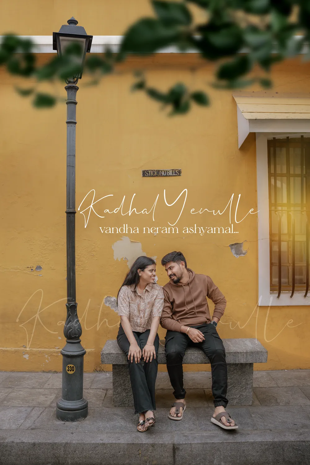 Couple seated against an ochre wall