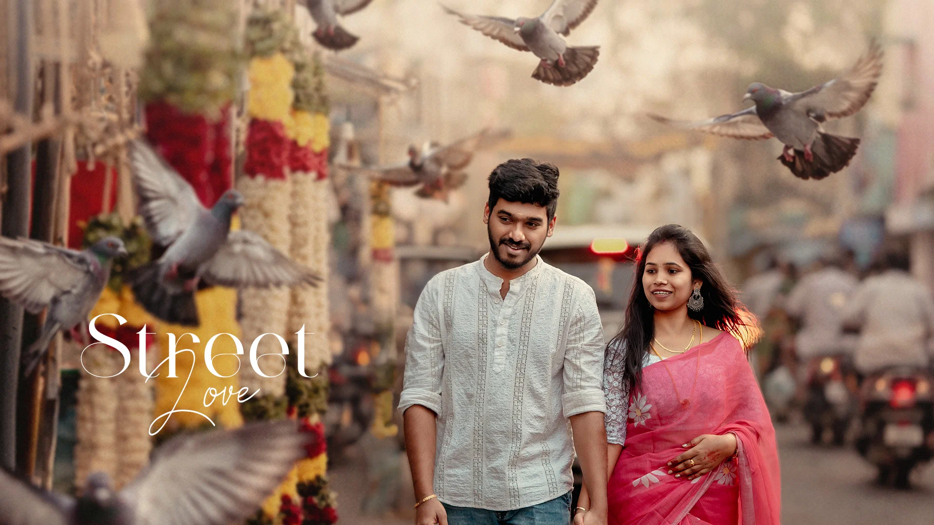Couple on a temple street as pigeons take flight