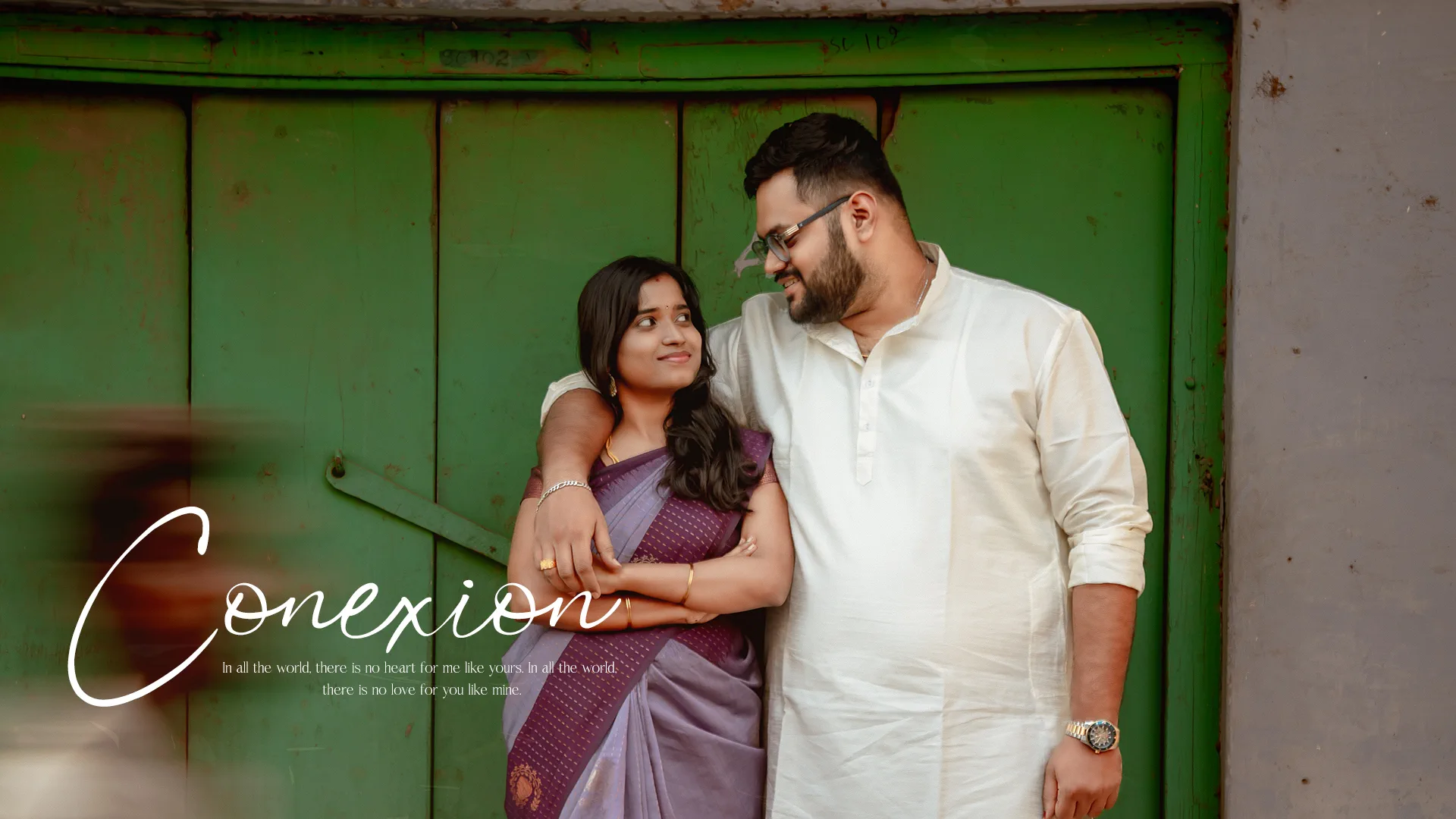 Couple against a weathered green door